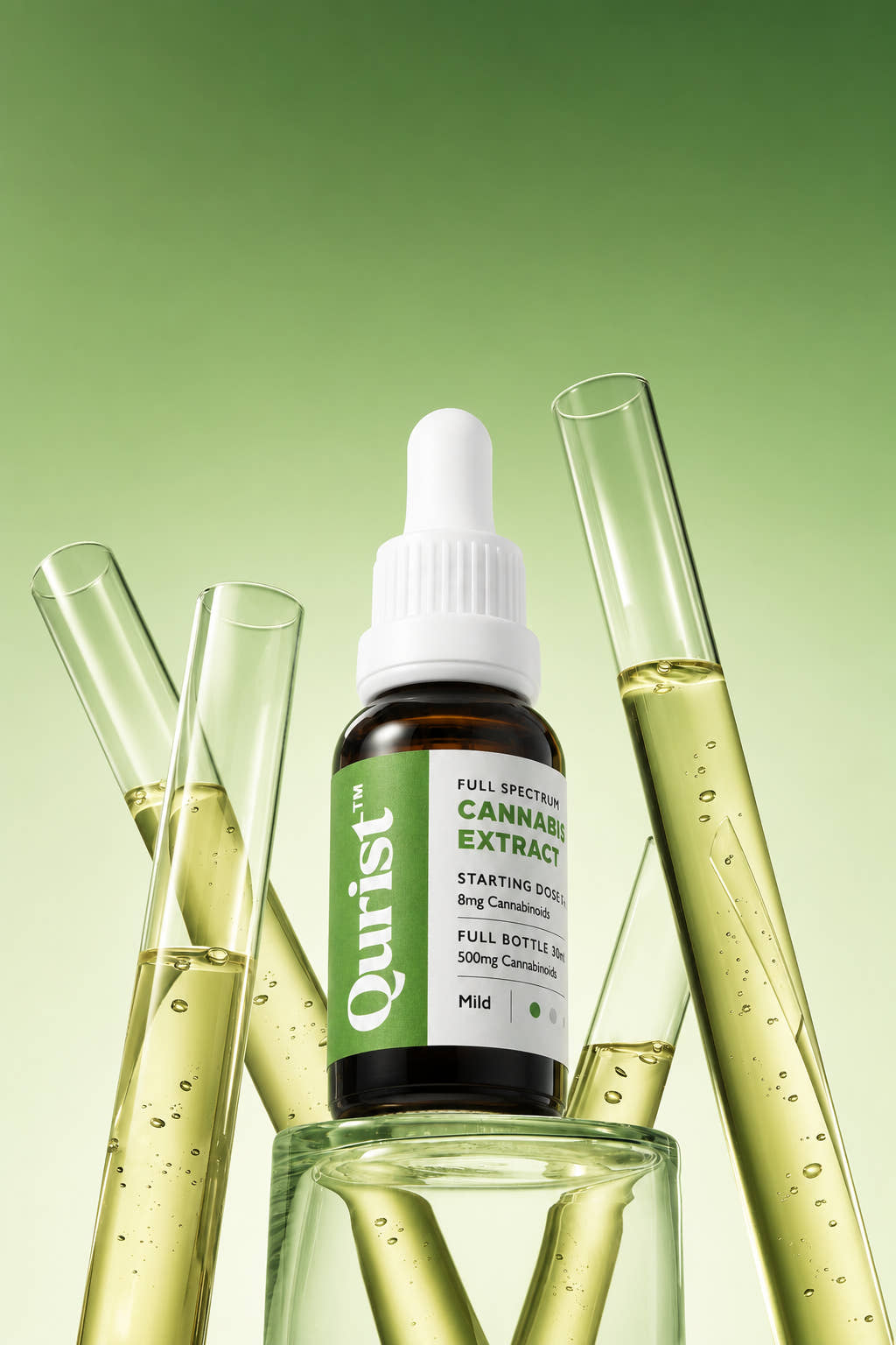 Qurist full spectrum cannabis extract bottle beside tubes of golden oil
