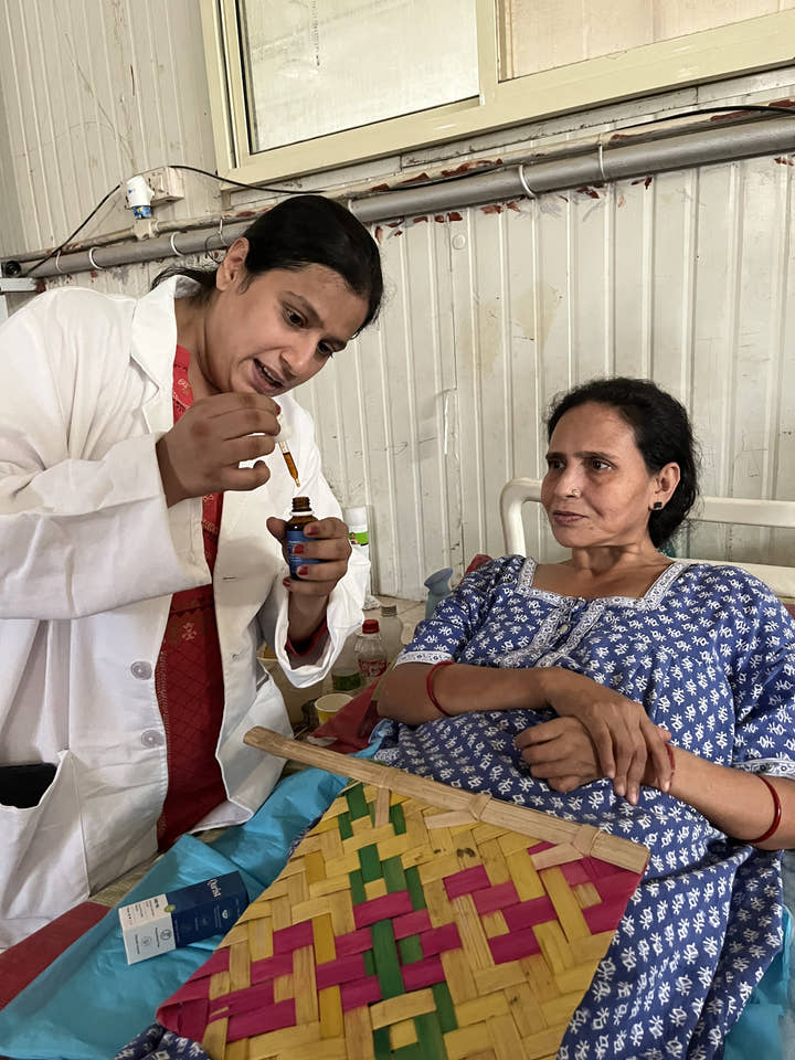 A practitioner administering Qurist CBD oil to a resident at a care home