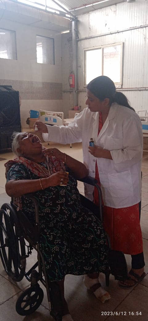 A practitioner giving Qurist CBD oil to a resident at an old age home