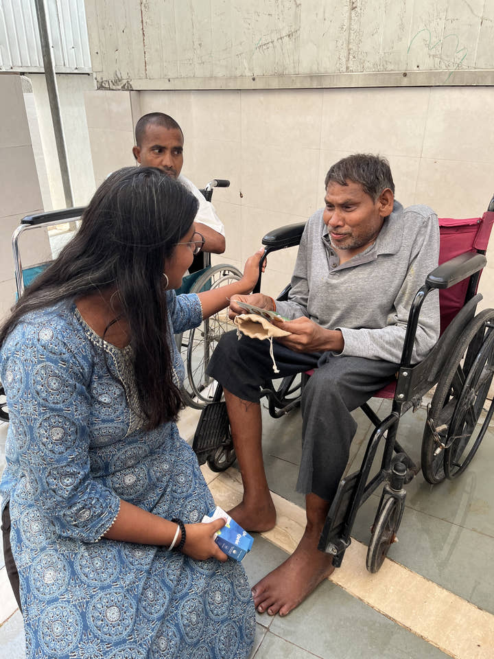 A Qurist team member handing a product to a resident at a care home