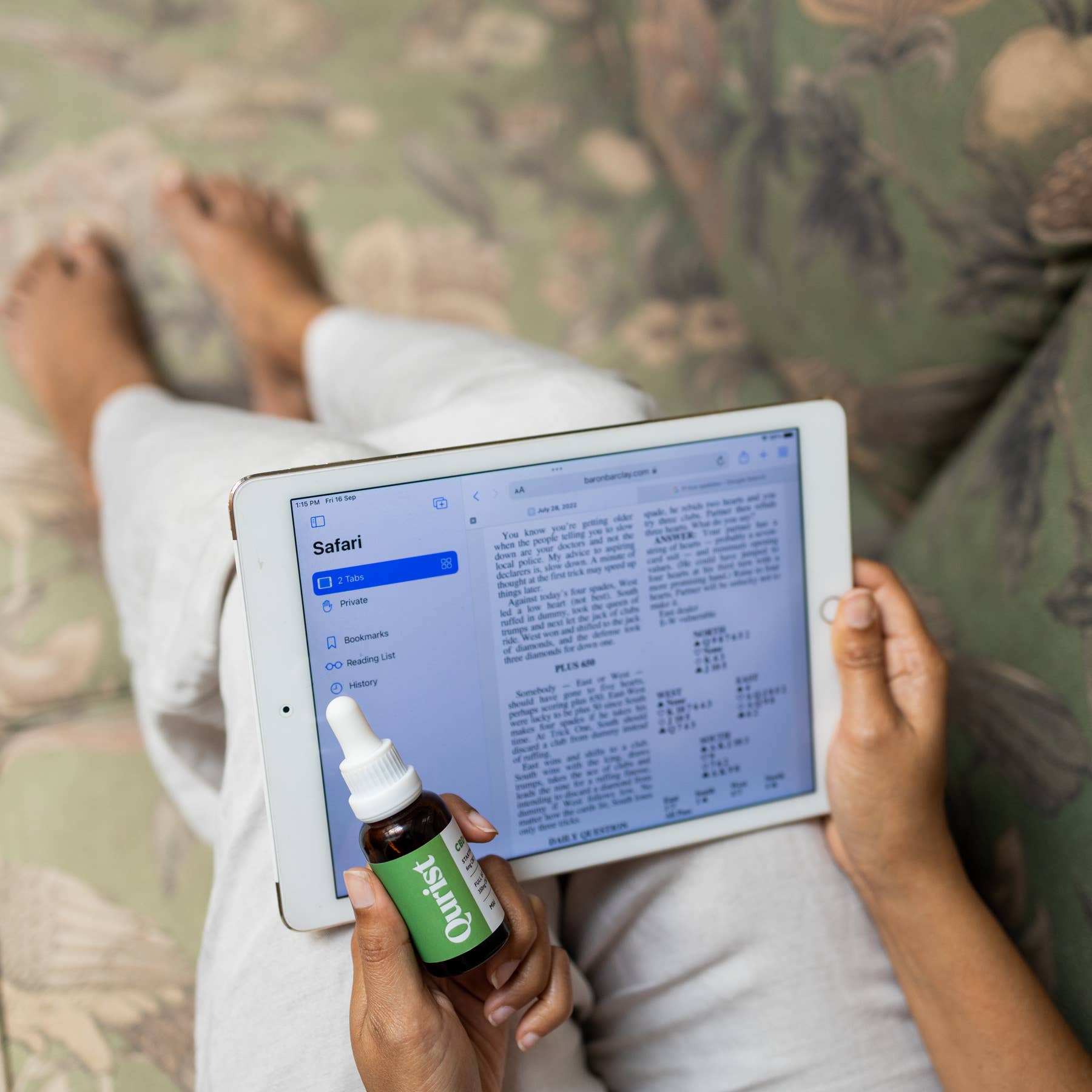 A Qurist customer relaxing at home with a bottle of Qurist CBD oil